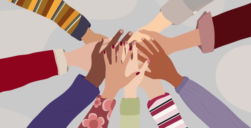 Illustration of multicultural hands reaching into a circle as a team