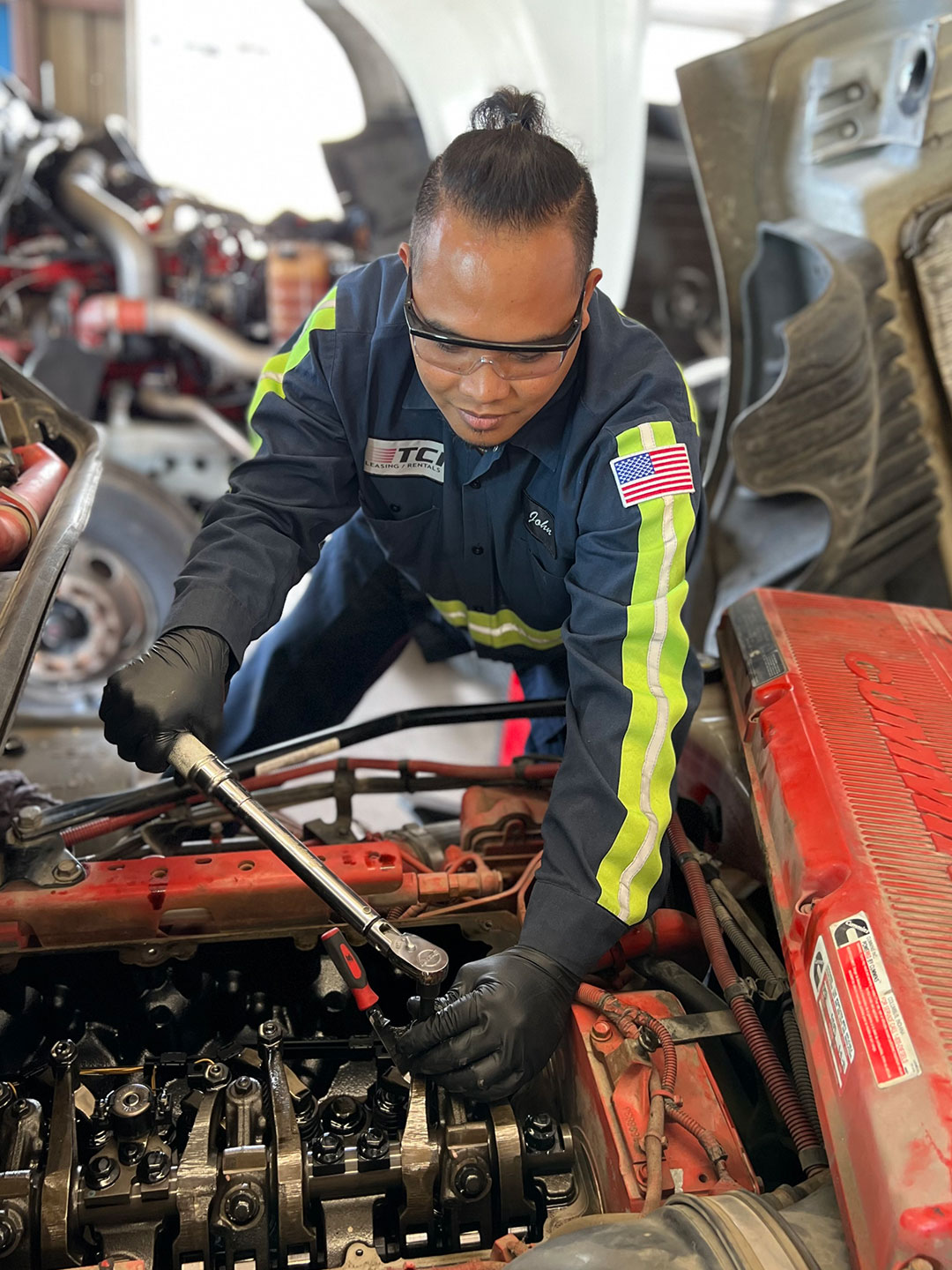 Technician working on Semi Engine with large wrench