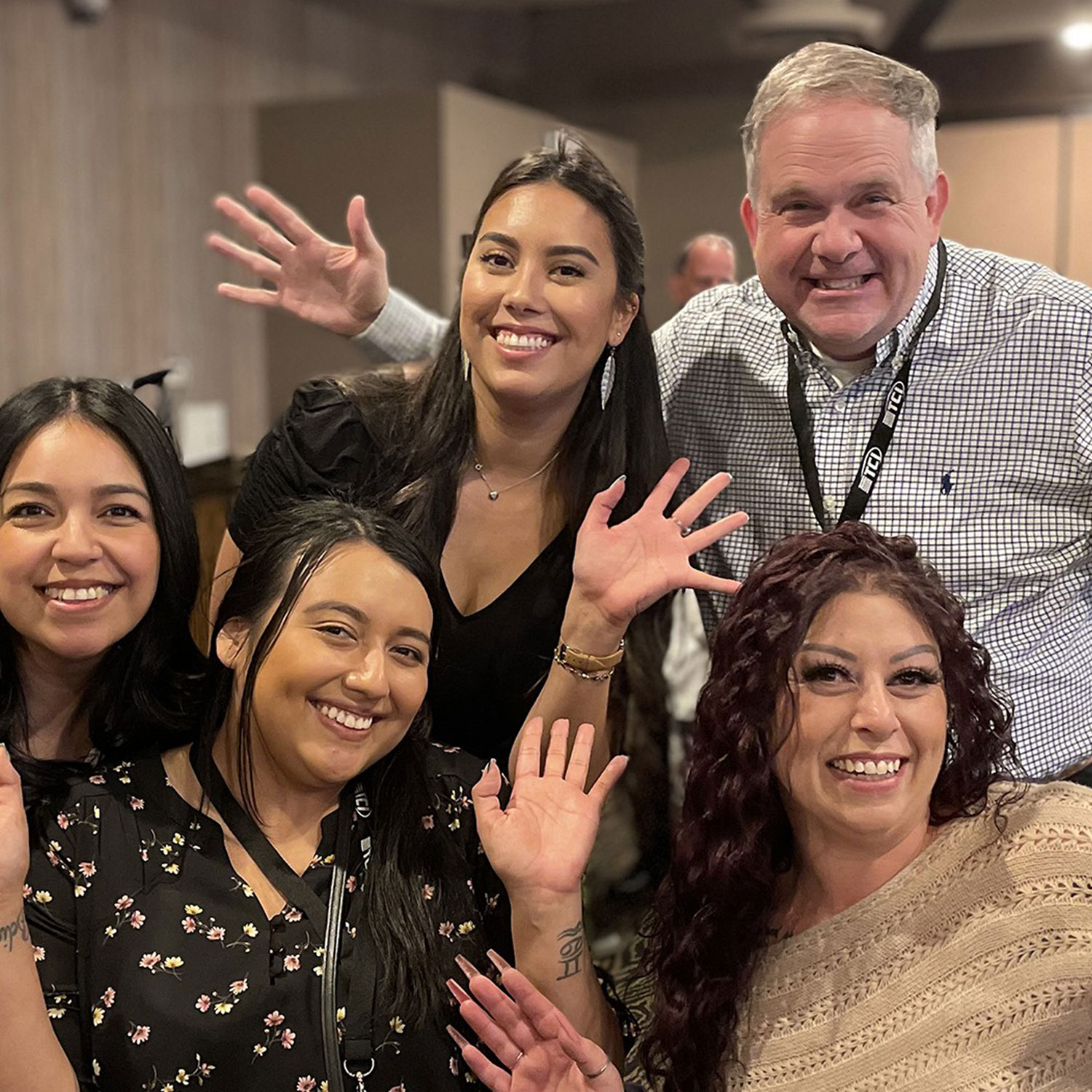 Group of TCI employees posing for the camera at a company event.