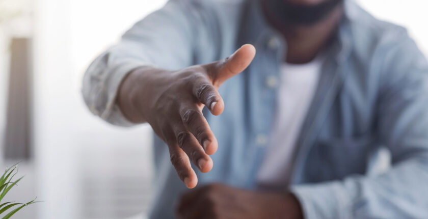 HR manager extending hand for handshake after successful job interview