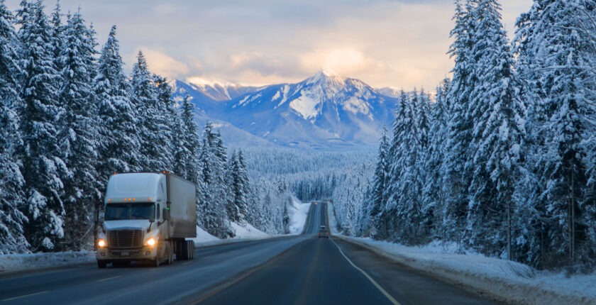 Truck driving through the mountains in winter