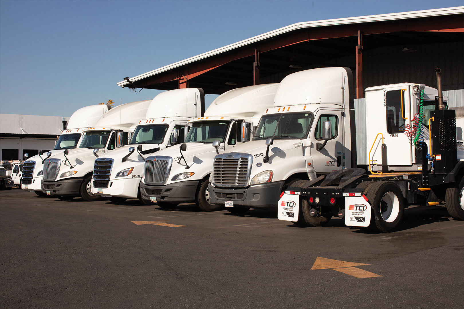 Row of white semi tractors in all shapes and sizes