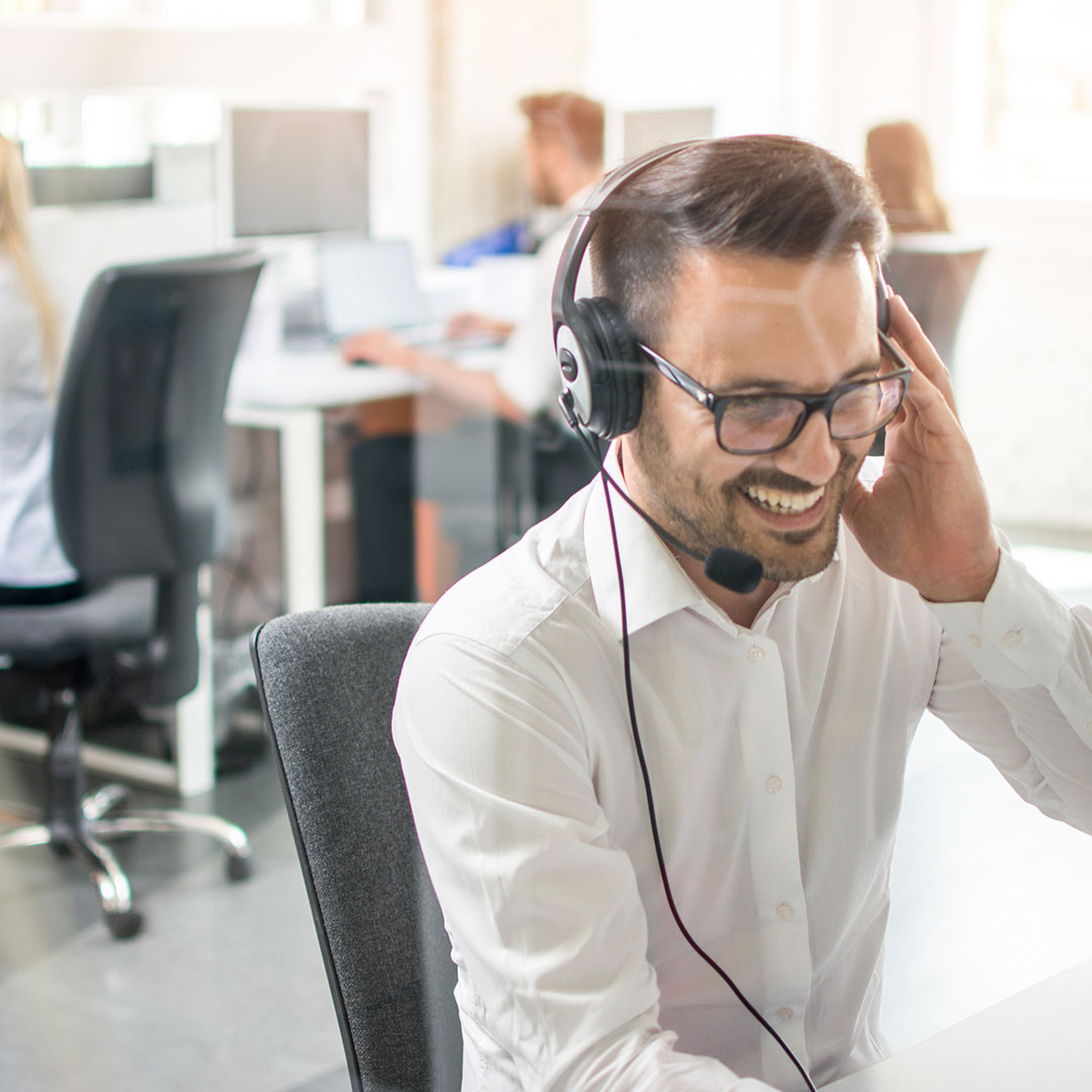 Man with phone headset on in office setting