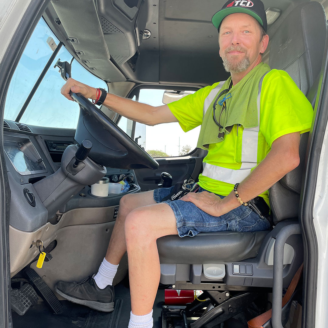 TCI driver up high in driver's seat with door open