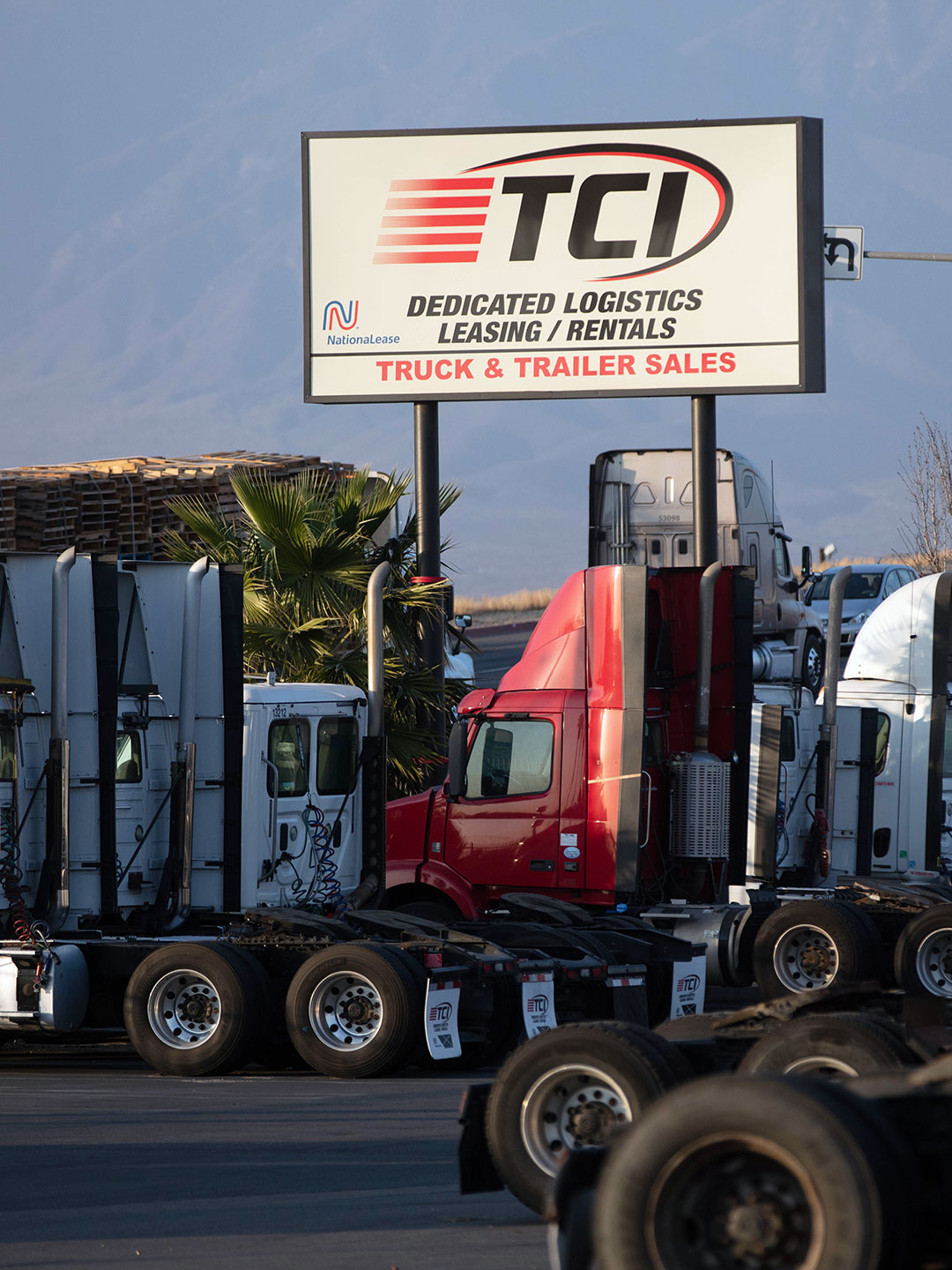 Sunset reflecting on TCI sign above trucks